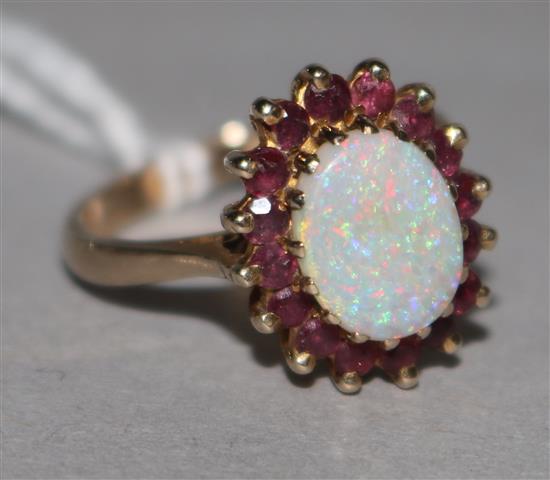 A 9ct gold, ruby and white opal cluster ring, size O.